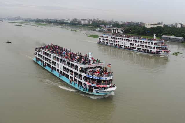 Bangladeshis ride packed ferries as they rush home to be with their families in their respective villages ahead of the Eid al-Fitr festival at the Sadarghat ferry terminal on the outskirts of Dhaka on August 7, 2013. The Eid al-Fitr, the biggest festive Muslim event, marks the end of the holy fasting month of Ramadan. (Photo by Munir uz Zaman/AFP Photo)