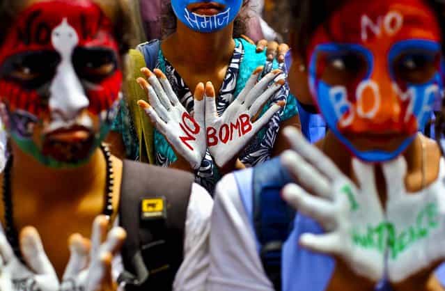 Students with their faces painted in colors, participate in a Hiroshima Day peace rally in Mumbai, India, on August 6, 2013. Tuesday marked the 68th anniversary of the world's first atomic bombing that killed as many as 140,000 people. (Photo by Rafiq Maqbool/Associated Press)