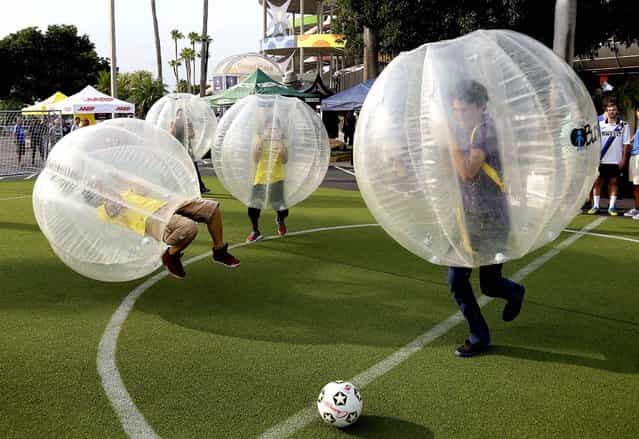 Fans play bubble soccer before the start of the Guinness International Champions Cup game between Juventus and Inter Milan in Miami, on August 6, 2013. (Photo by J. Pat Carter/Associated Press)