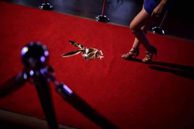A young woman walks towards a stage to be photographed while applying for a job as a Playboy bunny during a casting in Monterrey. Playboy is doing [Bunny Hunt 2013] castings in several Mexican cities for the Playboy casino in Cancun, on August 7, 2013. (Photo by Daniel Becerril /Reuters)