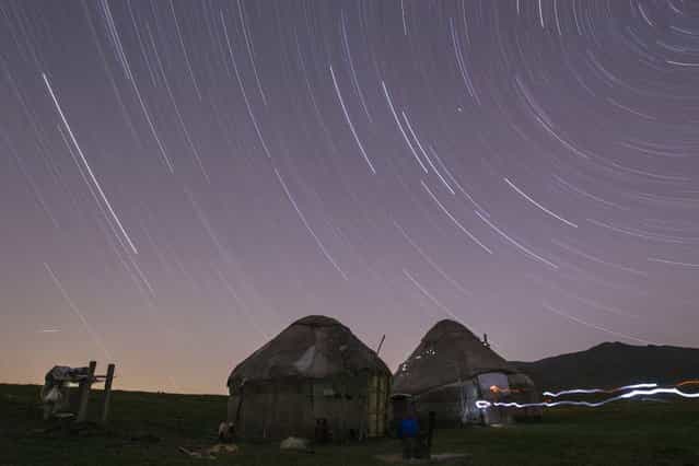 Star trails form over yurts, traditional nomad felt tents, in a long exposure picture on the mountainous Assy plateau, on August 5, 2013. (Photo by Shamil Zhumatov/Reuters)
