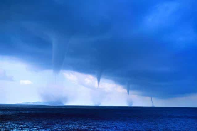 Photographer Roberto Giudici snapped this picture of four waterspouts as he was sailing off the Greek island of Orthoni, on August 3, 2013. (Photo by Roberto Giudici/Caters News)