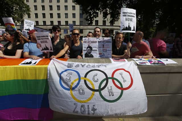 Activists participate at a protest against Russia's new law on gays, in central London, Saturday, August 10, 2013. Hundreds of protesters, called for the Winter 2014 Olympic Games to be taken away from Sochi, Russia, because of a new Russian law that bans [propaganda of nontraditional sexual relations] and imposes fines on those holding gay pride rallies. (Photo by Lefteris Pitarakis/AP Photo)