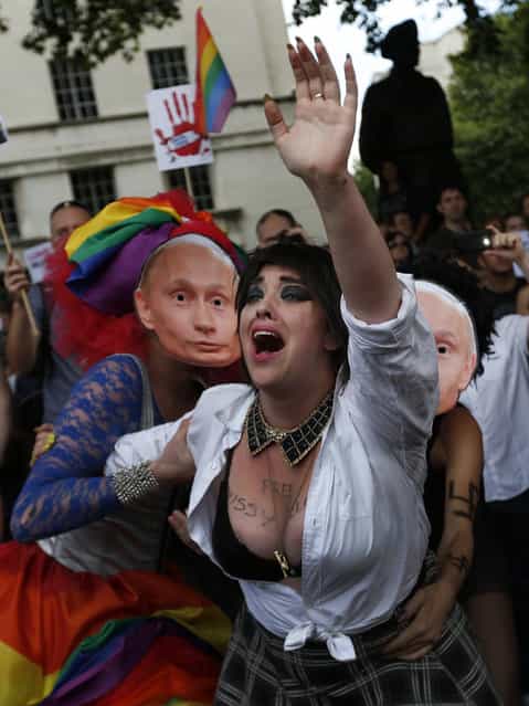 Activists stage a theatrical play where gays are prevented by others wearing masks depicting Russian President Vladimir Putin, during a protest against Russia's new law on gays, in central London, Saturday, August 10, 2013. Hundreds of protesters, called for the Winter 2014 Olympic Games to be taken away from Sochi, Russia, because of a new Russian law that bans [propaganda of nontraditional sexual relations] and imposes fines on those holding gay pride rallies. (Photo by Lefteris Pitarakis/AP Photo)