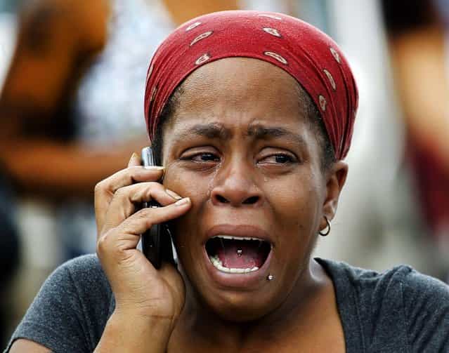 Nicole Webb cries while waiting for her 9-year-old son, a student at Ronald E. McNair Discovery Learning Academy in Decatur, Georgia, on August 20, 2013. A suspect was in custody after reports of gunfire at the elementary school. Superintendent Michael Thurmond said all students at the school were accounted for and safe and that he is not aware of any injuries. (Photo by John Bazemore/Associated Press)