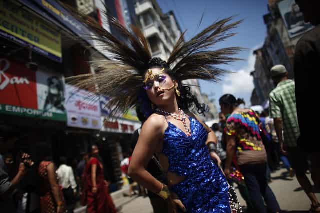 A participant poses in a Gay Pride rally in Katmandu, Nepal, Thursday, August 22, 2013. About 1,000 people, including gays, lesbians, transvestites and their supporters hold the rally that has now become an annual festival for sexual minorities to celebrate and to demand rights for their community. Organizers said the rally was an opportunity for the sexual minorities to come out in the open and also to educate the public. (Photo by Niranjan Shrestha/AP Photo)