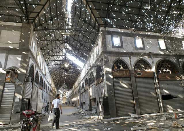 A man walks inside the damaged historical old souk of Homs August 19, 2013. (Photo by Yazan Homsy/Reuters)