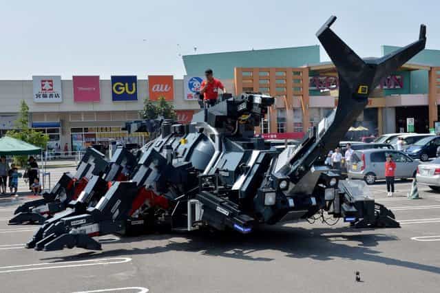 A large beetle-shaped robot [Kabutom RX-03], made by Japanese engineer Hitoshi Takahashi, is demonstrated in Higashi Ibaraki province, Japan, on August 15, 2013.The robot is 11-meters in length and weighing 17-tonnes, can walk with its six legs and can also blow smoke from its nose. (Photo by Yoshikazu Tsuno/AFP Photo)