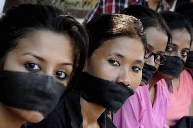 Members of the All Assam Photojournalist Association wear black sashes around their mouths during a protest against the rape of a photojournalist by five men inside an abandoned textile mill in Mumbai, in the northeastern Indian city of Guwahati, on August 24, 2013. The gang-rape of the 22-year-old journalist has drawn comparisons to an attack in December that led to nationwide protests and a revision of rape laws. (Photo by Utpal Baruah/Reuters)