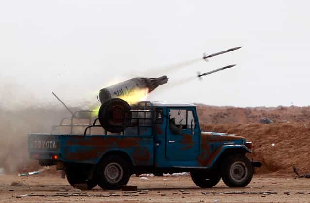 Rebel fighters launch rockets against Qaddafi forces at the frontline along the western entrance of Ajdabiyah on April 21. (Photo by Amr Abdallah Dalsh/Reuters)