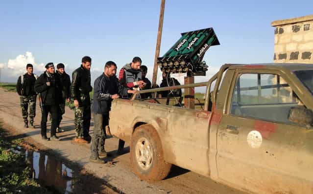 Free Syrian Army fighters stand beside a locally made anti-aircraft weapon near the Menagh military airport in Aleppo's countryside, on February 17, 2013. (Photo by Mahmoud Hassano/Reuters)