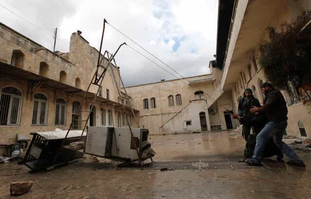 [Free Syrian Army] fighters use a homemade slingshot in old Aleppo, on January 29, 2013. (Photo by Zain Karam/Reuters)
