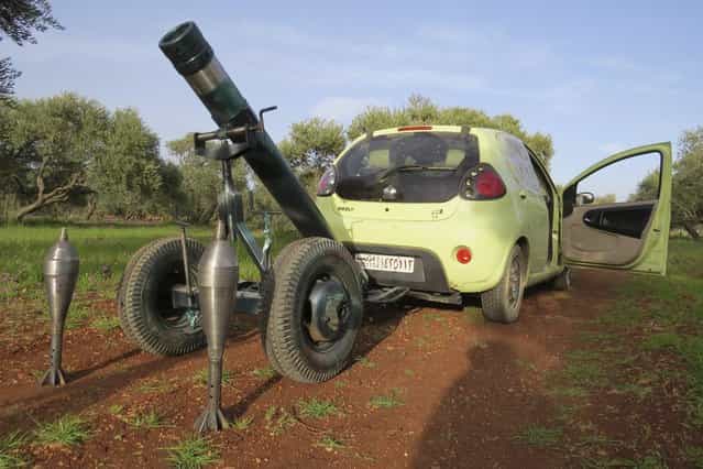 A mortar that belongs to the Free Syrian Army fighters, is pictured attached to a car to be pulled to the front line where clashes with forces loyal to Syria's President Bashar al-Assad are taking place, in Binnish in Idlib province March 13, 2013. (Photo by Mohamed Kaddoor/Reuters/Shaam News Network)
