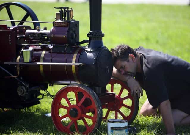 An exhibitor prepares a miniature steam engine to show at the Cornish Steam and Country Fair at the Stithians Showground on August 16, 2013 near Penryn, England. The annual show, now in 58th year, is one of Cornwall's largest outdoor events and is one of the UK's most popular and respected steam rallies. (Photo by Matt Cardy/Getty Images)