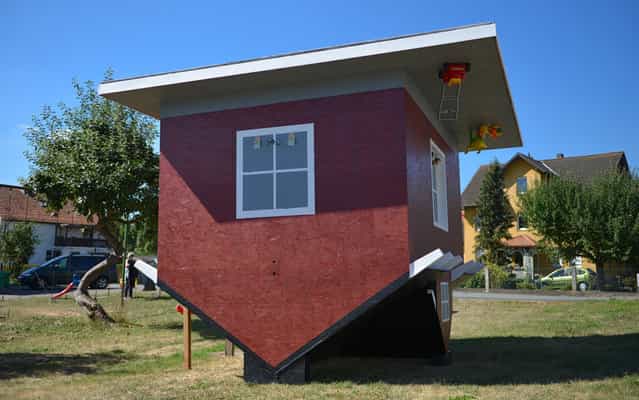 An upside down model of a house is build in Wellen, central Germany, on September 5, 2013. A full scaled house will be erected 2014 at the Edersee, central Germany. (Photo by Uwe Zucchi/AFP Photo/DPA)