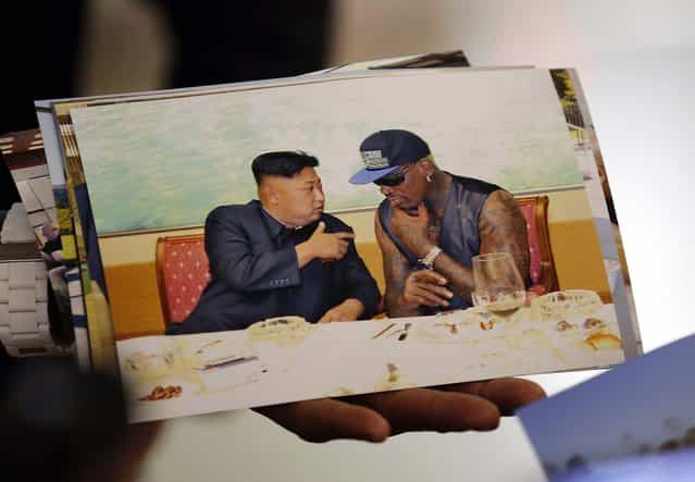 Former basketball star Dennis Rodman shows a picture which he took with North Korean leader Kim Jong-un as he arrives at Beijing Capital International Airport, on September 7, 2013. Kim again met Rodman during his second visit to North Korea this year, North Korea's state news agency said on Saturday, but made no mention on whether the two discussed the fate of a jailed American missionary. (Photo by Kim Kyung-Hoon/Reuters)