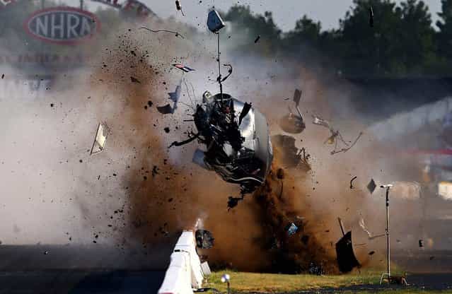 USA: NHRA pro mod driver Tim Tindle crashes during qualifying for the US Nationals at Lucas Oil Raceway in Clermont, Indiana, on September 1, 2013. Tindle walked away from the accident. (Photo by Mark J. Rebilas/USA TODAY Sports)