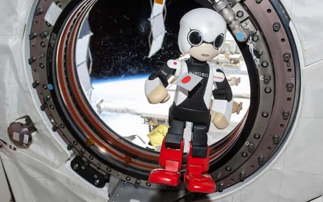 Humanoid communication robot Kirobo holding Japanese national flag and speaking during session to check success of its first conveyance into space, at International Space Station. (Photo by NASA/Reuters/2013.Kibo-Robot)