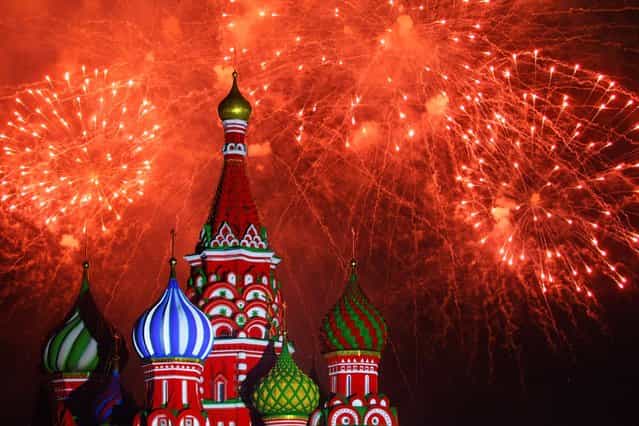 In this Tuesday, September 3, 2013 photo, fireworks explode in the sky over St. Basil Cathedral during the [Spasskaya Tower] International Military Orchestra Music Festival at the Red Square in Moscow, Russia. The festival started on Sunday, September 1 in Moscow and would last until Sunday, September 8. (Photo by Denis Tyrin/AP Photo)