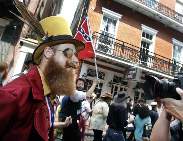 Jeffrey Moustache keeps eyes straight ahead as a photographer singles him out during a parade through the French Quarter kicking off the fourth annual Just For Men National Beard and Moustache Championships Saturday, September 7, 2013 in New Orleans. Moustache was competing in the Verdi division. Contestants competed in 18 different categories including Dali, full beard natural and sideburns. (Photo by Susan Poag/AP Photo)