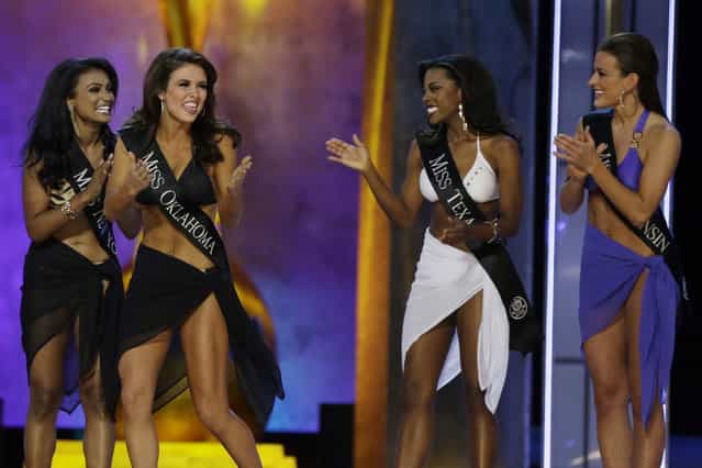 Miss Oklahoma Kelsey Griswold, center, reacts after finding out she's advancing beyond the lifestyle competition as Miss New York Nina Davuluri, from left, Miss Texas Ivana Hall, and Miss Wisconsin Paula Mae Kuiper look on during the Miss America 2014 pageant, Sunday, September 15, 2013, in Atlantic City, N.J. (Photo by Mel Evans/AP Photo)