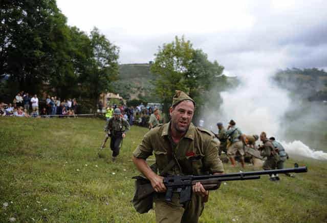 An actor takes part in a re-enactment of the "Battle of Areces" that took place during the Spanish Civil War, in Grullos, north of Spain, September 14, 2013. The re-enactment of the historic 1937 battle was organised by the Frente del Nalon Association. (Photo by Eloy Alonso/Reuters)