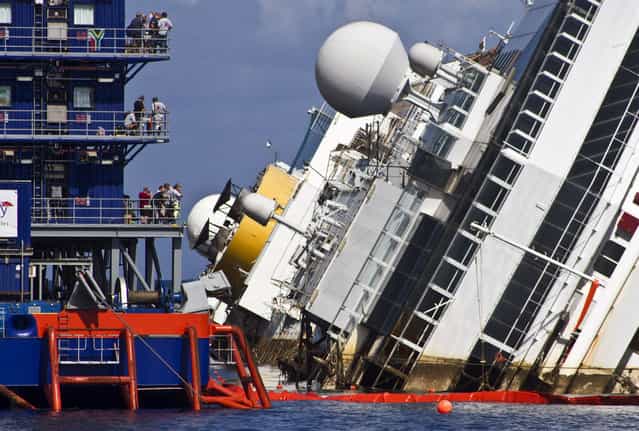 After about a two-hour delay because of thunderstorms, the salvage operation of the Costa Concordia cruise ship was to begin early off the coast of Italy, near the island of Giglio, 16th September 2013. (Photo by Valerio Nicolosi/Demotix)