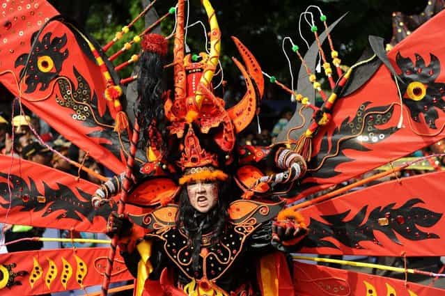 A model wearing Kebo Geni costume attends the Banyuwangi Ethno Carnival 2013 on September 7, 2013 in Banyuwangi, Indonesia. The central theme to the Banyuwangi Ethno Carnival III is The Legend of Kebo-keboan Blambangan and consists of three main parades which are Kebo Geni, Kebo Tirto Bayu, Kebo Bumi, and comprises more than 250 performers. (Photo by Robertus Pudyanto/Getty Images)