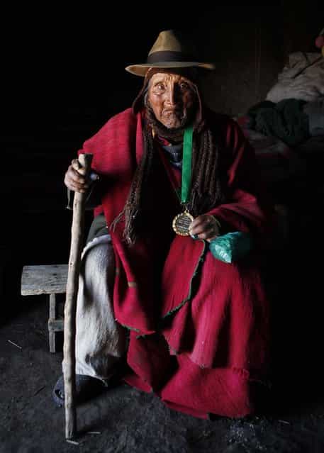 Carmelo Flores, a native Aymara, holds his medal, recently given to him by the governor of La Paz, as he poses for a photo inside his home in the village of Frasquia, Bolivia, on September 16, 2013. The La Paz governor awarded the medal to Flores, recognizing him as the oldest person on the planet. If Bolivia's public records are correct, Flores is the oldest living person ever documented. They say he turned 123 in July. (Photo by Juan Karita/Associated Press)
