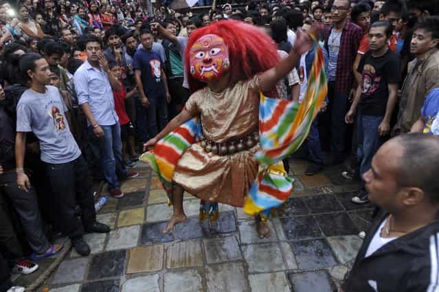 Nepalese mask dance locally known as Lakhe dance is performed during the 4th day of Indra Jatra festival at Basantapur Durbar Square in Kathmand, Nepal, on September 19, 2013. The week-long festival celebrates [Indra], the king of gods and the god of rains. (Photo by Prakash Mathema/AFP Photo)
