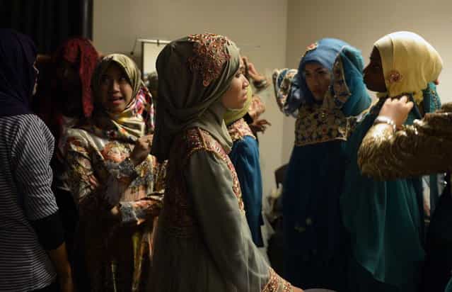 Contestants of the Muslimah World pageant prepare for the grand final of the contest in Jakarta on September 18, 2013. (Photo by Adek Berry/AFP Photo)