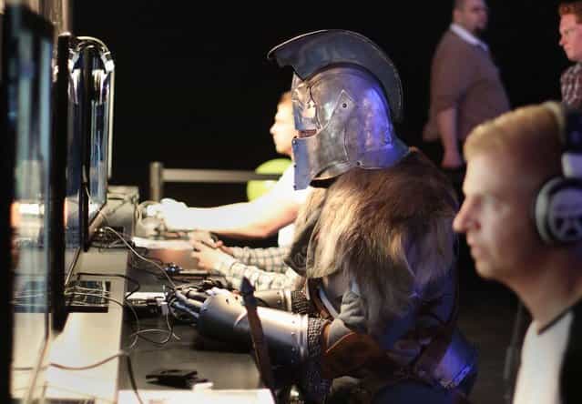 Gamers, with one dressed a character from the game, playing the Dark Souls II game at the Eurogamer Expo at Earls Court in London, September 26, 2013. (Photo by Philip Toscano/PA Wire)