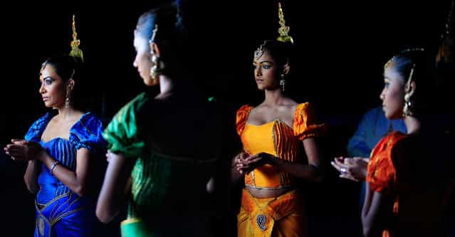 Traditional dancers wait for guests during the Kramaski factory's 20th anniversary celebrations in Katunayake, about 31 km (19 miles) north of Colombo September 27, 2013. (Photo by Dinuka Liyanawatte/Reuters)
