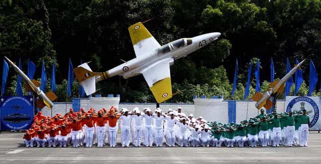 Indian Air Force trainees dressed in the Indian tri-colored flag perform during the passing out parade ceremony of their seniors in Bangalore, on September 27, 2013. (Photo by Aijaz Rahi/Associated Press)