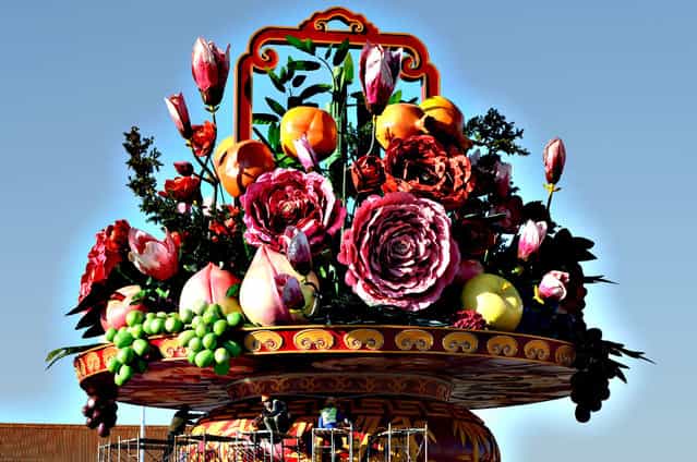 Workers install a giant vase containing fruit and flowers as part of the upcoming Chinese National Day celebrations at Tiananmen Square in Beijing on September 24, 2013. The seven-day holiday sees millions of members of China's newly wealthy and mobile middle-class travel locally and abroad. (Photo by Mark Ralston/AFP Photo)