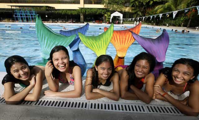 Filipino mermaid swimming students pose for photographs after a lesson by the Philippines Mermaid Swimming Academy at Dive Republic pool in Quezon City, eastern Manila, Philippines, 15 June 2013. The Philippine Mermaid Swimming Academy (PMSA) was created in 2012 in Boracay by Normeth Preglo of The Philippines and US swimming instructor Djuna Rocha. The swimming lessons were brought to Manila in April 2013. The price for a two-hour class is 37 US dollars. (Photo by Dennis M. Sabangan/EPA)