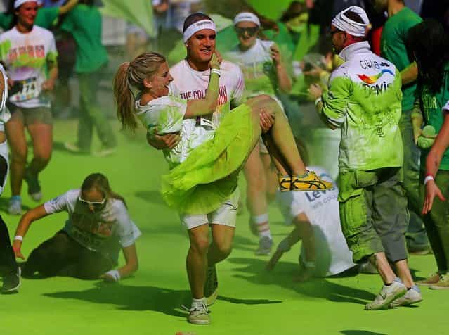 People take part in The Color Run in Brussels, on September 29, 2013. (Photo by Yves Herman/Reuters)