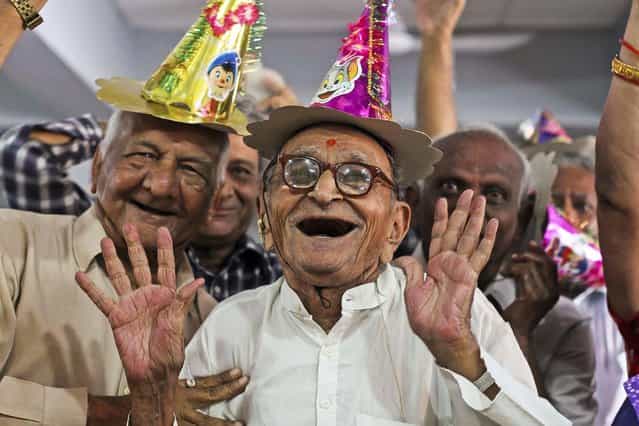 Elderly people participate in celebrations to mark International Day of Older Persons at an old age home in Ahmadabad, India, on October 1, 2013. (Photo by Ajit Solanki/Associated Press)