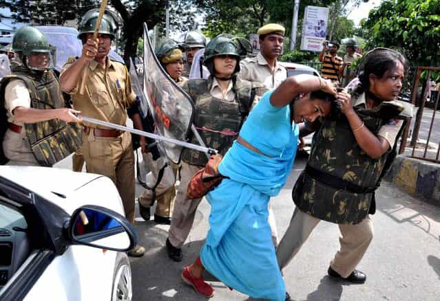 Over 100 activists and supporters of the peasants' organization Krishak Mukti Sangram Samity, along with their president Akhil Gogoi, were detained by police when they infringed into the city's Dispur Last Gate area breaking police barricades to stage Gana Satyagraha outside the capital complex on the eve of Gandhi Jayanti, on October 1, 2013. (Photo AFP Photo/STR)