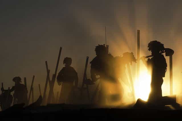 Jamie's photograph, [Sunset Soldiers], shows sappers demolishing a former British Base. (Photo by Jamie Peters/PA Wire)