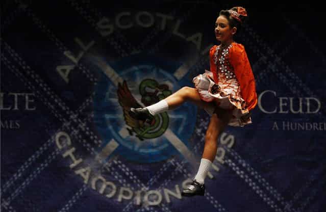 Dancer Niamh O'Connor performs in one of the heats during the All Scotland Championships in Irish Dancing at the Royal Concert Hall in Glasgow, Scotland February 22, 2013. The championship takes place until Monday with over 2000 dancers taking part from over 300 dance schools from as far afield as North America, South Africa, Australia and Russia. (Photo by David Moir/Reuters)