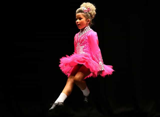 Orlaith Brown McMonagle from Ireland performs in front of judges in one of the heats in the All Scotland Championships in Irish Dancing being held at the Royal Concert Hall in Glasgow. Almost 2,000 competitors are taking part in Glasgow for one of the world's biggest Irish dancing competitions. The dancers represent some 300 dance schools from across the world, from as far afield as North America, South Africa, Australia and Russia. (Photo by Andrew Milligan/PA Wire)