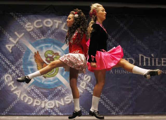 Two dancers pass each other as they compete in a heat during the All Scotland Championships in Irish Dancing at the Royal Concert Hall in Glasgow, Scotland February 23, 2013. The championships, which continue until Monday, attract over 2000 dancers from more than 300 dance schools, from countires such as North America, South Africa, Australia and Russia. (Photo by David Moir/Reuters)