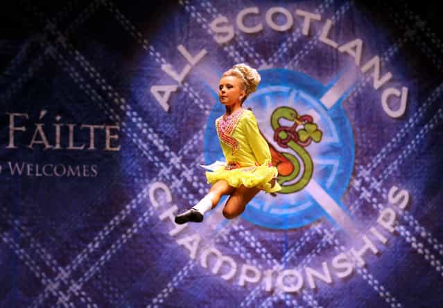 Sarah McDaid from Ireland performs in front of judges in one of the heats in the All Scotland Championships in Irish Dancing being held at the Royal Concert Hall in Glasgow. Almost 2,000 competitors are taking part in Glasgow for one of the world's biggest Irish dancing competitions. The dancers represent some 300 dance schools from across the world, from as far afield as North America, South Africa, Australia and Russia. (Photo by Andrew Milligan/PA Wire)