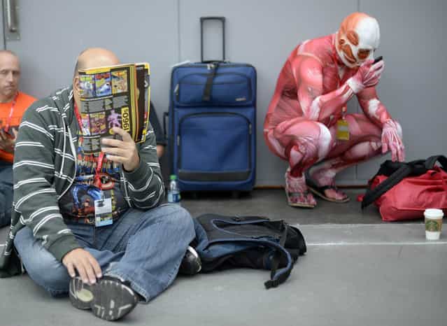 Fans in costume arrive for the opening session of the 2013 New York Comic Con at the Jacob Javits Center on October 10, 2013. The four day event which runs October 10–13 is the largest pop culture event on the East Coast. (Photo by Timothy Clary/AFP Photo)