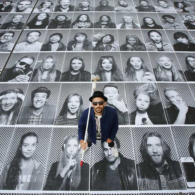 French artist JR poses with some of his giant portraits at Somerset House for his Inside Out project on October 7, 2013 in London, England. Displaying at the Lazarides gallery and also on hoardings at a building site opposite the Old Bailey, the exhibition is comprised of giant black and white images of members of the public who are photographed in a mobile studio mounted on the back of a small truck. The Inside Out photo booth truck is located on the River Terrace of Somerset House from 3rd – 11th October 2013. (Photo by Peter Macdiarmid/Getty Images)