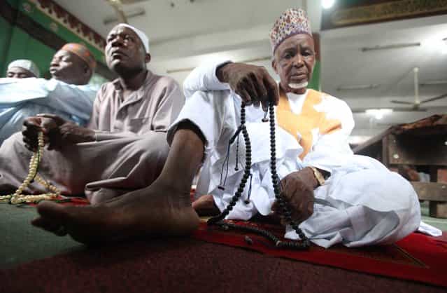 Nigeria Muslims offer prayers during Eid al-Adha prayers to mark the end of the holy month of Hajji in Lagos, Nigeria, Tuesday, October 15, 2013. Traditionally Muslims all over the world slaughter cattle and goats and distribute the meat to the needy, during the Eid al-Adha festival which honors the prophet Abraham for preparing to sacrifice his son Ishmael on the order of God, who was testing his faith. (Photo by Sunday Alamba/AP Photo)