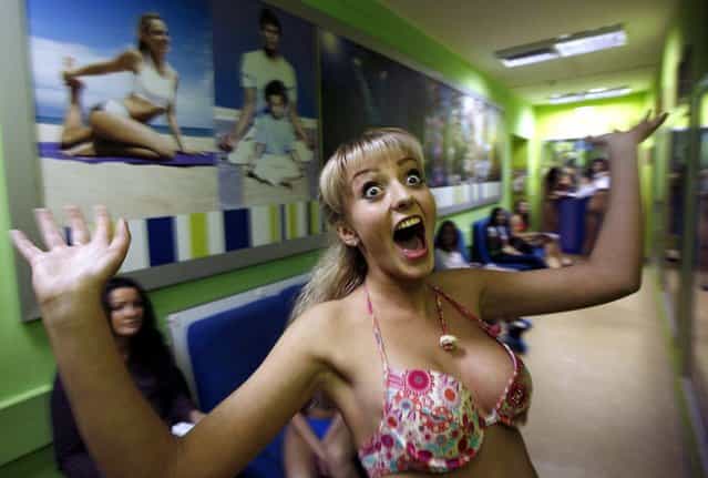 A contestant reacts backstage after participating in the first round of auditions for the [Krasa Rossii 2014] (Beauty of Russia 2014) national beauty contest in the Siberian city of Krasnoyarsk October 12, 2013. The winner of the beauty pageant, where the finals will be held in the capital Moscow, will represent Russia at international beauty competitions. (Photo by Ilya Naymushin/Reuters)