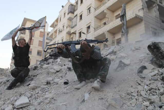 [Free Syrian Army] fighters fire their weapons during what the FSA said were clashes with forces loyal to Syria's President Bashar al-Assad in Aleppo's Karm al-Jabal district October 15, 2013. (Photo by Saad Abobrahim/Reuters)