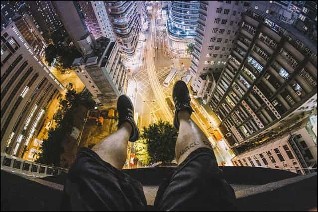 Daredevil photographer Andrew Tso has risked life and limb by taking a series of stunning images from the rooftops of Hong Kong's giant skyscrapers. (Photo by Andrew Tso/Barcroft Media)
